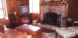 living room with wood burning fireplace